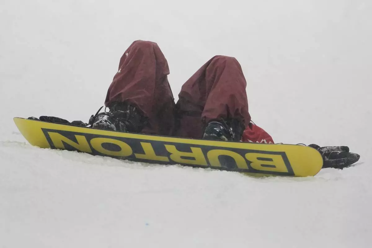Canada's Mark McMorris reacts after crashing during a snowboard big air training session at the 2026 Winter Olympics, in Livigno, Italy, Wednesday, Feb. 4, 2026. (AP Photo/Lindsey Wasson)