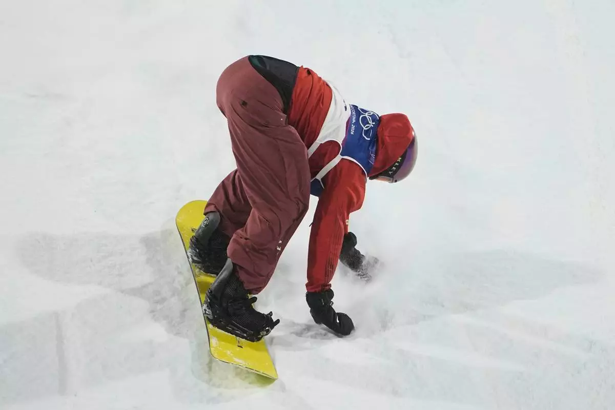 Canada's Mark McMorris crashes during a snowboard big air training session at the 2026 Winter Olympics, in Livigno, Italy, Wednesday, Feb. 4, 2026. (AP Photo/Lindsey Wasson)