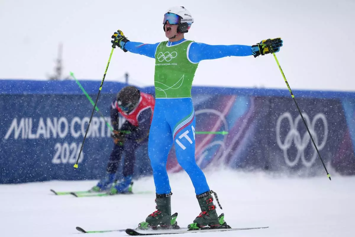 Italy's Simone Deromedis (9) celebrates after competing during the men's ski cross final at the 2026 Winter Olympics, in Livigno, Italy, Saturday, Feb. 21, 2026. (AP Photo/Julia Demaree Nikhinson)