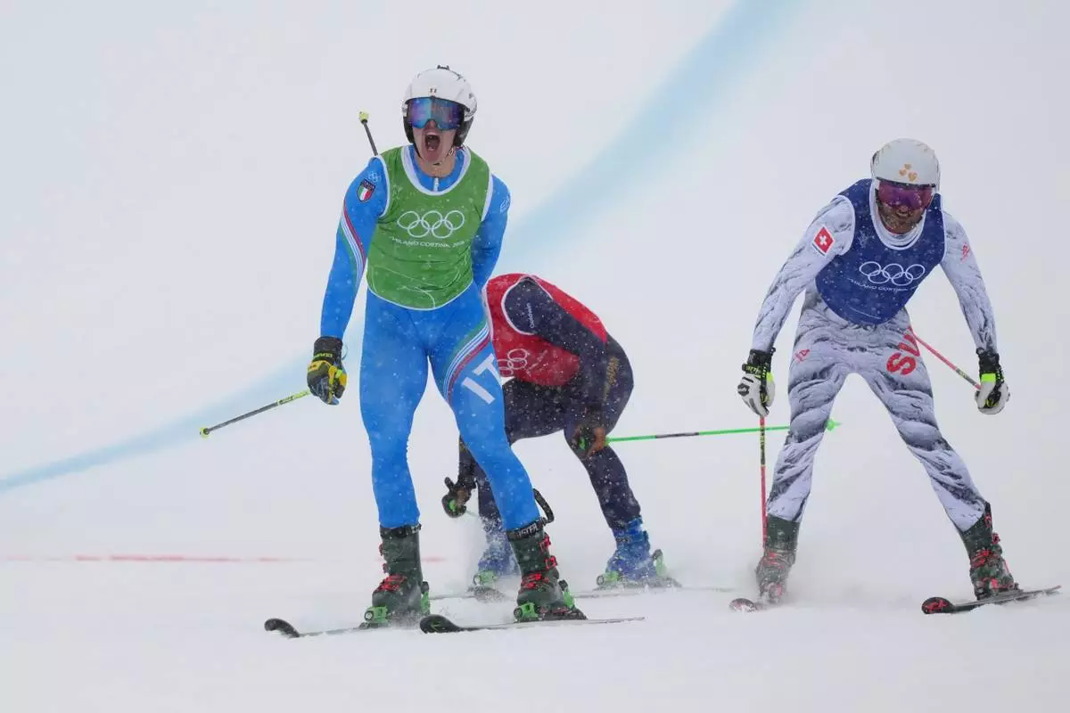 Italy's Simone Deromedis (9) celebrates after competing during the men's ski cross final at the 2026 Winter Olympics, in Livigno, Italy, Saturday, Feb. 21, 2026. (AP Photo/Julia Demaree Nikhinson)