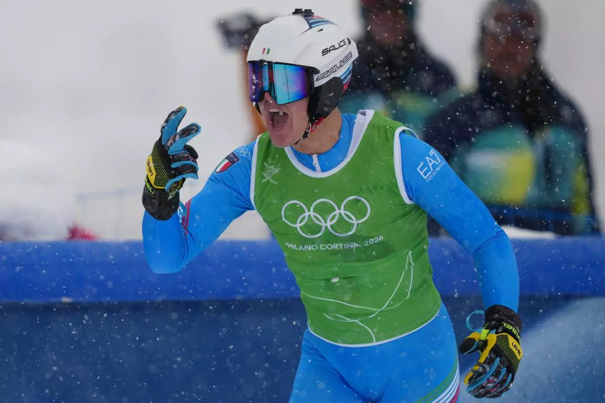 Italy's Simone Deromedis (9) celebrates after competing during the men's ski cross final at the 2026 Winter Olympics, in Livigno, Italy, Saturday, Feb. 21, 2026. (AP Photo/Julia Demaree Nikhinson)