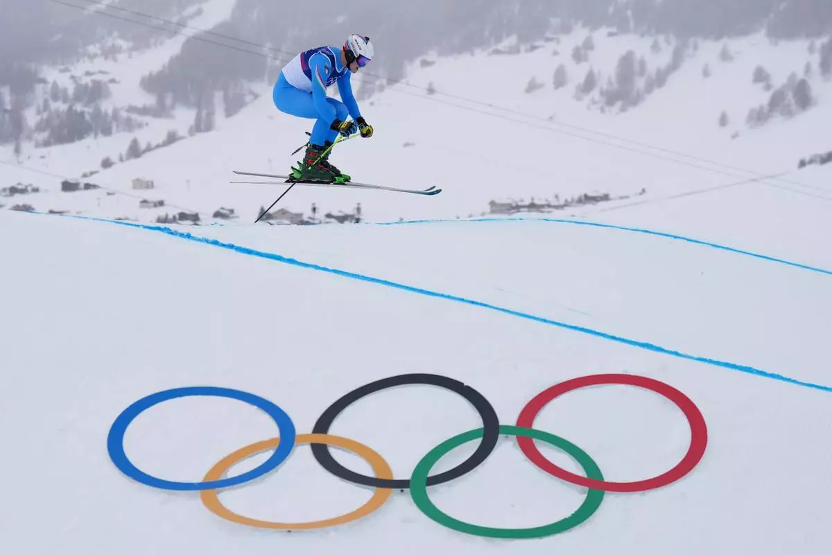 Italy's Simone Deromedis (15) competes during the men's ski cross qualifying at the 2026 Winter Olympics, in Livigno, Italy, Saturday, Feb. 21, 2026. (AP Photo/Abbie Parr)