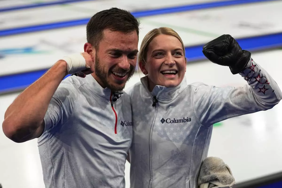 United States' Korey Dropkin, left, and United States' Cory Thiesse react following their semi-finals round of the mixed doubles curling match against Italy, at the 2026 Winter Olympics, in Cortina d'Ampezzo, Italy, Monday, Feb. 9, 2026. (AP Photo/Fatima Shbair)