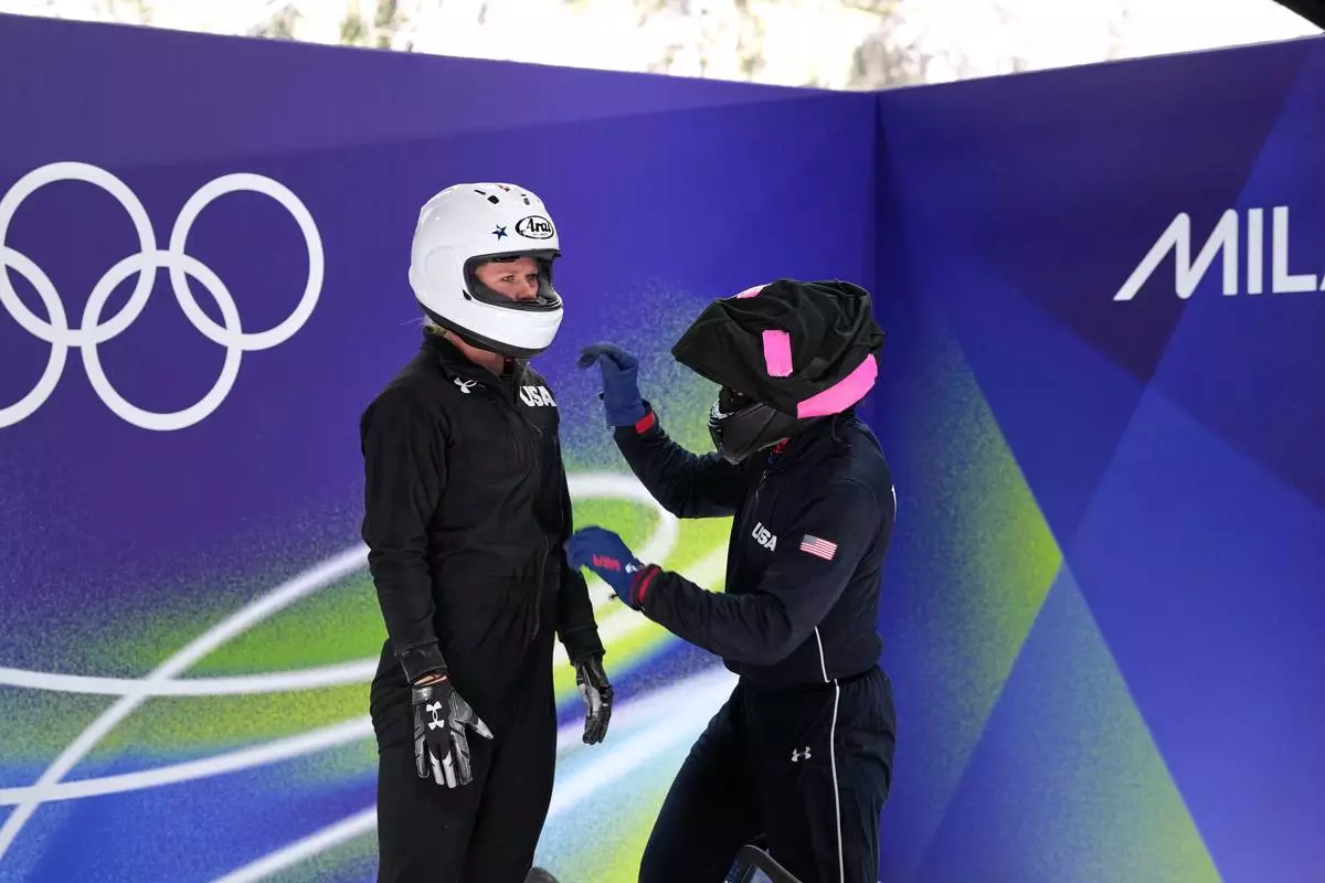 United States' Elana Meyers Taylor, right, and her pusher Jadin O'Brien prepare to start for a two women bobsled training sessionat the 2026 Winter Olympics, in Cortina d'Ampezzo, Italy, Wednesday, Feb. 18, 2026. (AP Photo/Aijaz Rahi)