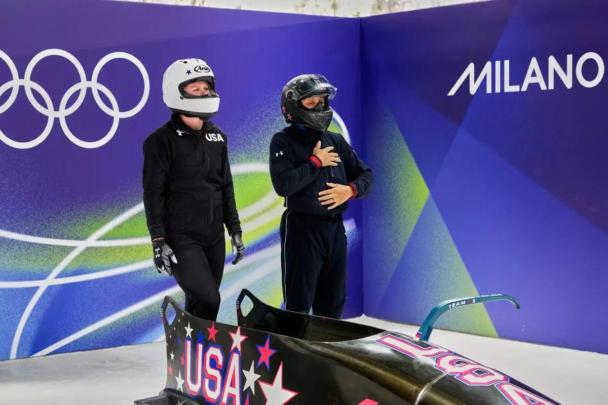 United States' Elana Meyers Taylor, right, and her pusher Jadin O'Brien prepare to start for a two women bobsled training sessionat the 2026 Winter Olympics, in Cortina d'Ampezzo, Italy, Wednesday, Feb. 18, 2026. (AP Photo/Aijaz Rahi)