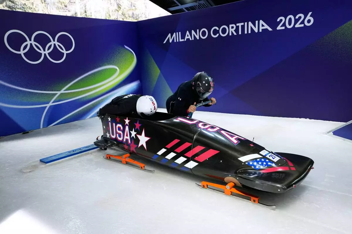 United States' Elana Meyers Taylor, right, and her pusher Jadin O'Brien start for a two women bobsled training sessionat the 2026 Winter Olympics, in Cortina d'Ampezzo, Italy, Wednesday, Feb. 18, 2026. (AP Photo/Aijaz Rahi)