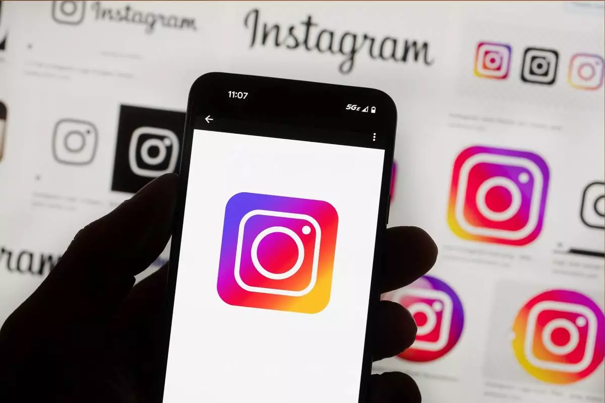 FILE - The Instagram logo is seen on a cell phone in Boston, Oct. 14, 2022. (AP Photo/Michael Dwyer, File)
