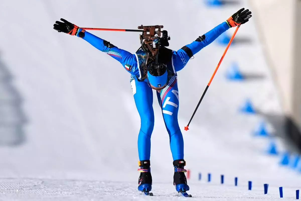 Lisa Vittozzi, of Italy, bows as she wins gold during the women's 10-kilometer pursuit biathlon race at the 2026 Winter Olympics in Anterselva, Italy, Sunday, Feb. 15, 2026. (AP Photo/Andrew Medichini)