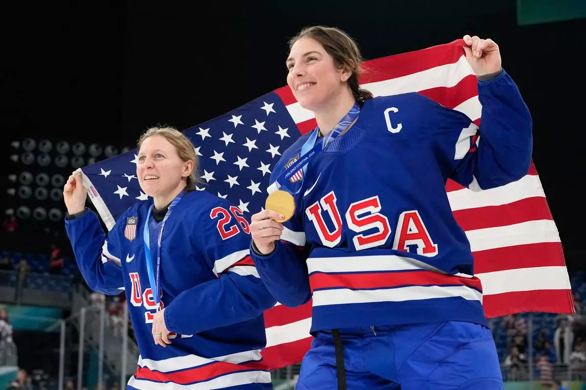United States' Kendall Coyne, left, and United States' Hilary Knight celebrate after victory ceremony for women's ice hockey at the 2026 Winter Olympics, in Milan, Italy, Thursday, Feb. 19, 2026. (AP Photo/Hassan Ammar)