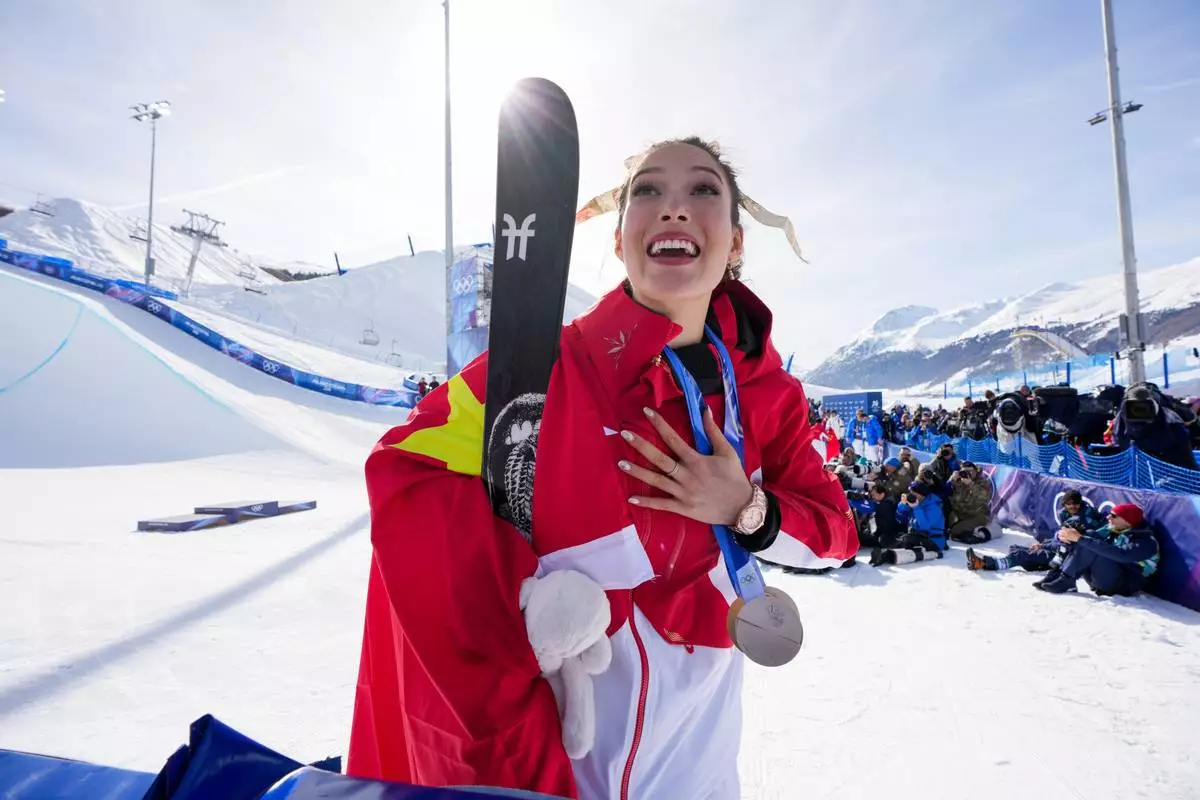Gold medalist China's Eileen Gu celebrates winning the women's freestyle skiing halfpipe final at the 2026 Winter Olympics, in Livigno, Italy, Sunday, Feb. 22, 2026. (AP Photo/Julia Demaree Nikhinson)