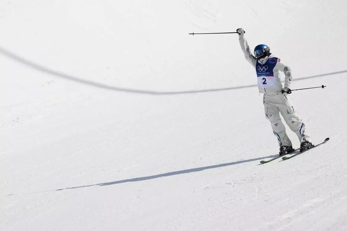 China's Eileen Gu celebrates during the women's freestyle skiing halfpipe final at the 2026 Winter Olympics, in Livigno, Italy, Sunday, Feb. 22, 2026. (AP Photo/Lindsey Wasson)