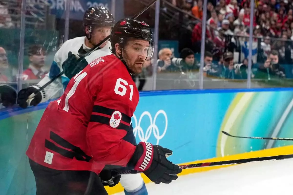 Canada's Mark Stone (61) challenges with Finland's Olli Maatta (3) during a men's ice hockey semifinal game between Canada and Finland at the 2026 Winter Olympics, in Milan, Italy, Friday, Feb. 20, 2026. (AP Photo/Hassan Ammar)