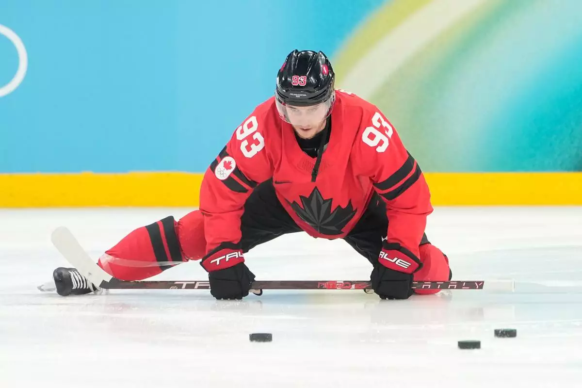 Canada's Mitch Marner warms up before a men's ice hockey gold medal game between Canada and the United States at the 2026 Winter Olympics, in Milan, Italy, Sunday, Feb. 22, 2026. (AP Photo/Hassan Ammar)