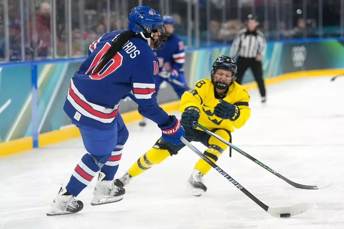 United States' Laila Edwards (10) challenges with Sweden's Hilda Svensson (8) during a women's ice hockey semifinal game between the United States and Sweden at the 2026 Winter Olympics, in Milan, Italy, Monday, Feb. 16, 2026. (AP Photo/Hassan Ammar)