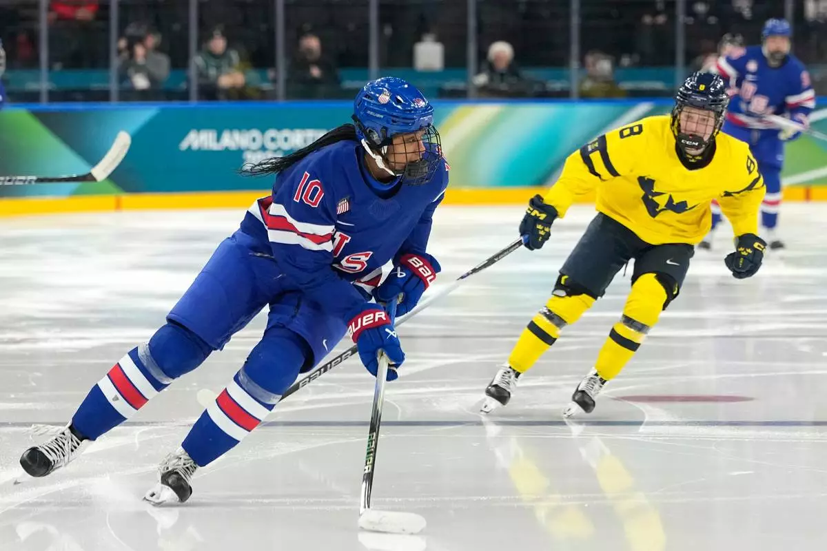 United States' Laila Edwards (10) is challenged by Sweden's Hilda Svensson (8) during a women's ice hockey semifinal game between the United States and Sweden at the 2026 Winter Olympics, in Milan, Italy, Monday, Feb. 16, 2026. (AP Photo/Hassan Ammar)