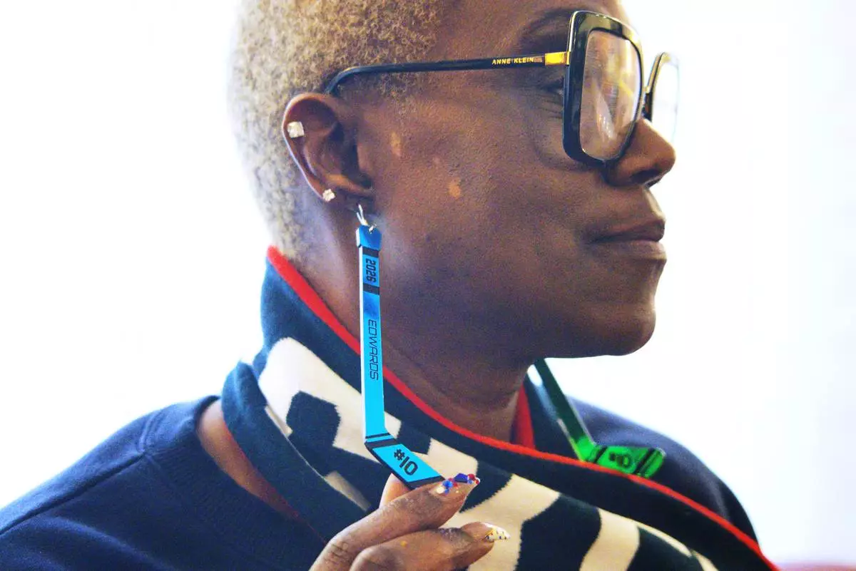 Charone Gray-Edwards, Laila Edwards’ mother, displays hockey stick earrings with Laila’s name and jersey number on them, during the 2026 Winter Olympics, in Milan, Italy, Monday, Feb. 16, 2026. (AP Photo/ Annie Risemberg)