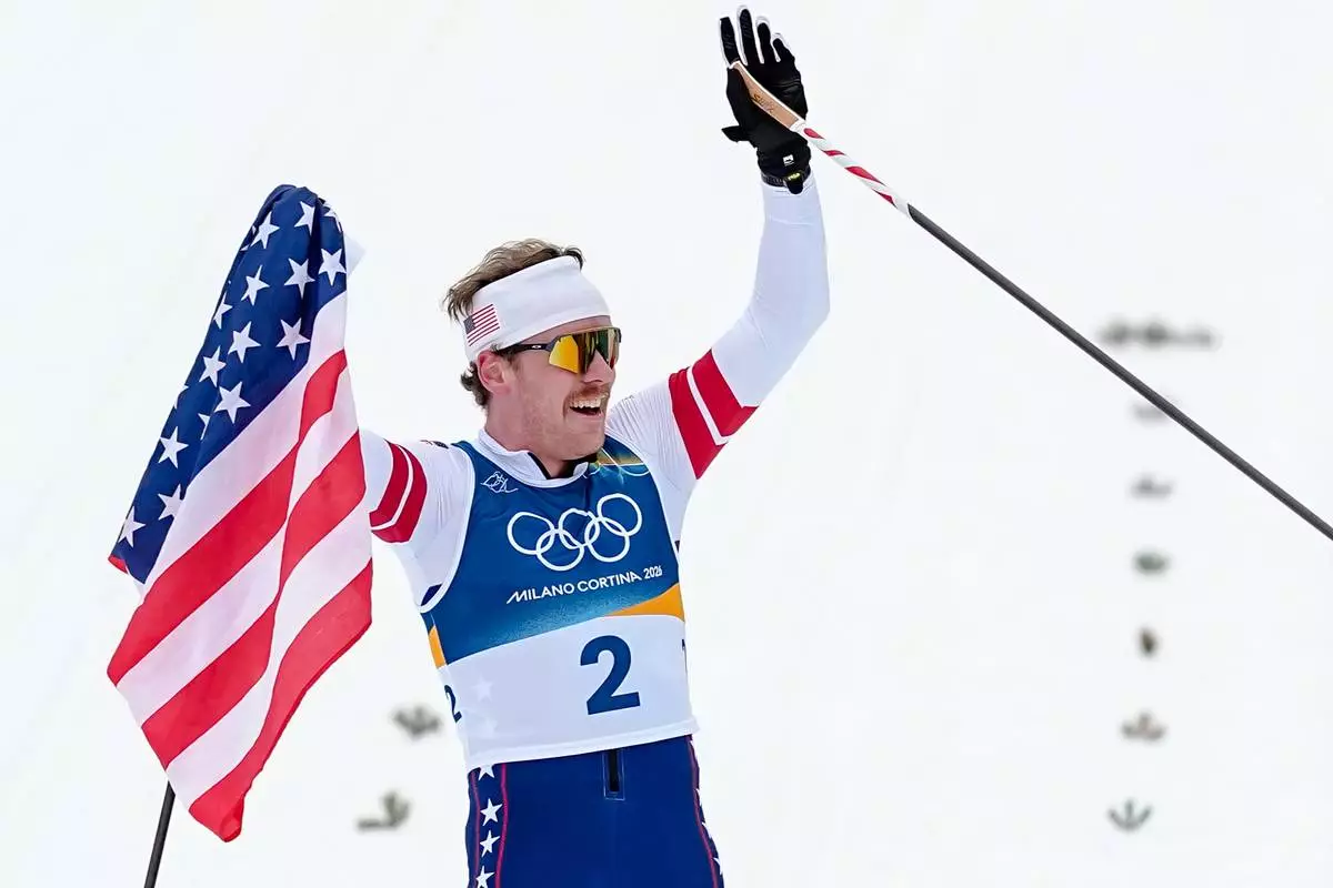 Ben Ogden, of the United States celebrates after winning the silver medal in the cross-country skiing men's sprint classic at the 2026 Winter Olympics, in Tesero, Italy, Tuesday, Feb. 10, 2026. (AP Photo/Matthias Schrader)