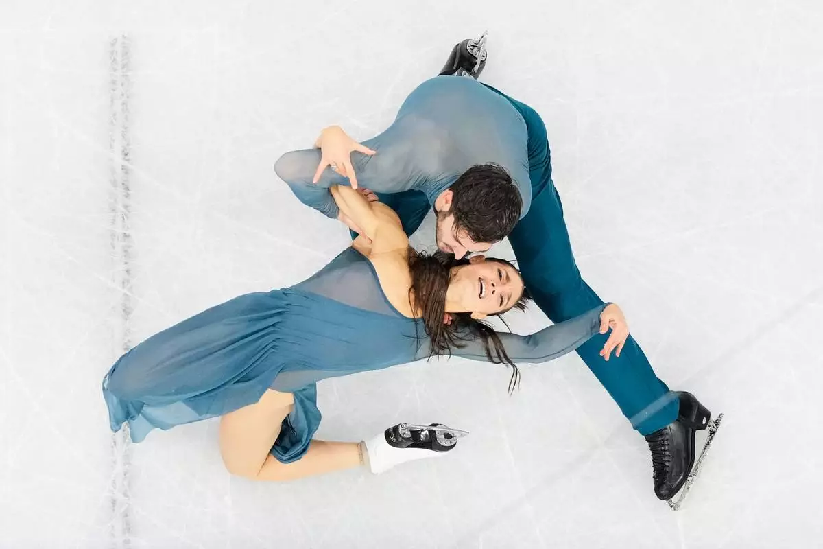 Laurence Fournier Beaudry and Guillaume Cizeron of France compete during the ice dancing free skate in figure skating at the 2026 Winter Olympics, in Milan, Italy, Wednesday, Feb. 11, 2026. (AP Photo/Bernat Armangue)