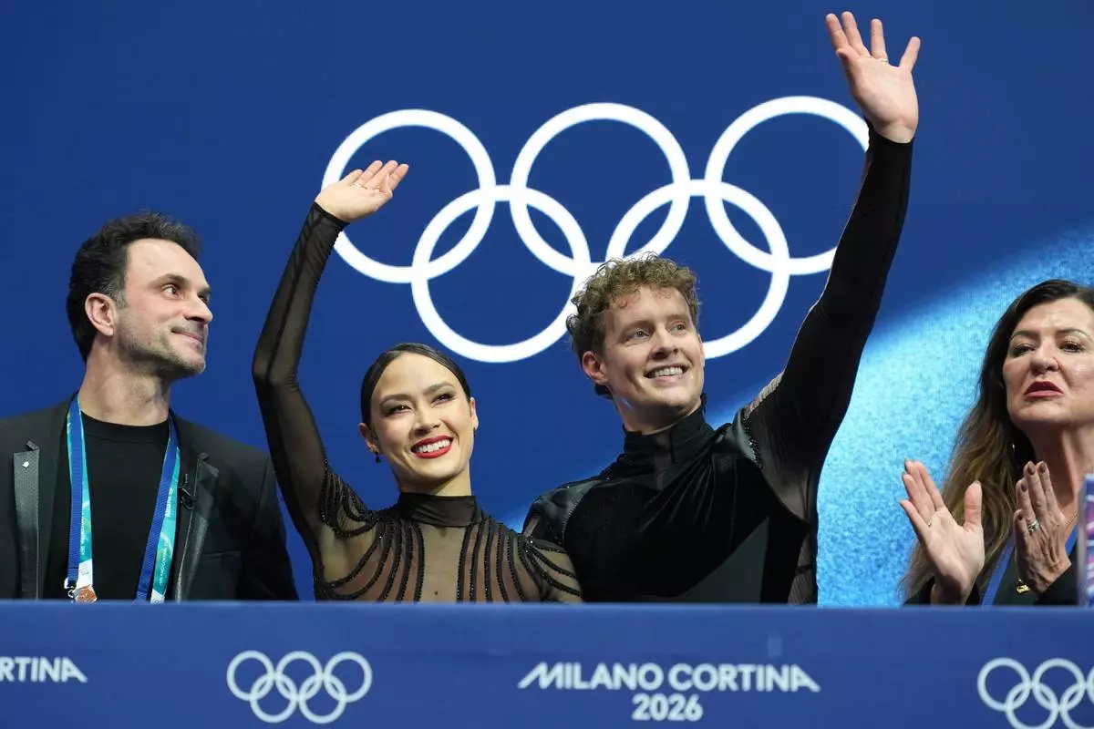 Madison Chock and Evan Bates of the United States react after competing during the ice dancing free skate in figure skating at the 2026 Winter Olympics, in Milan, Italy, Wednesday, Feb. 11, 2026. (AP Photo/Stephanie Scarbrough)