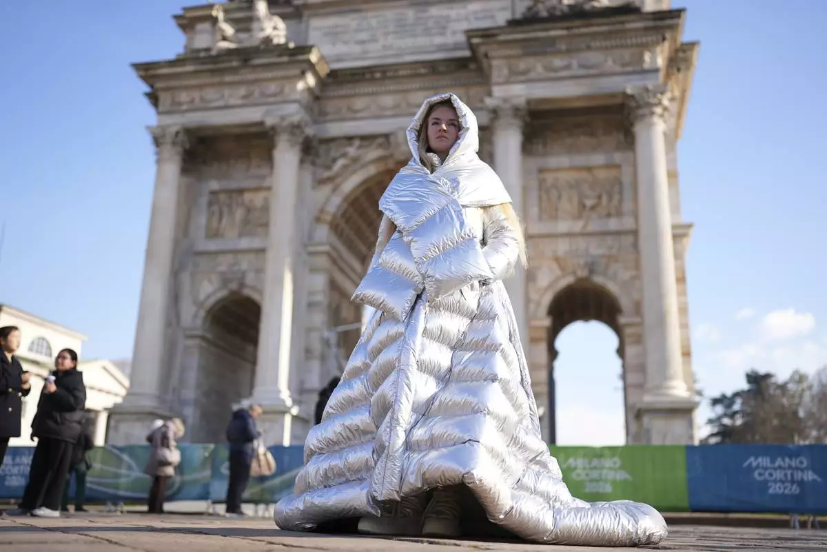 Anastasia Kucherova stands near the Arco della Pace during the 2026 Winter Olympics, in Milan, Italy, Monday, Feb. 16, 2026. (AP Photo/Andrea Rosa)