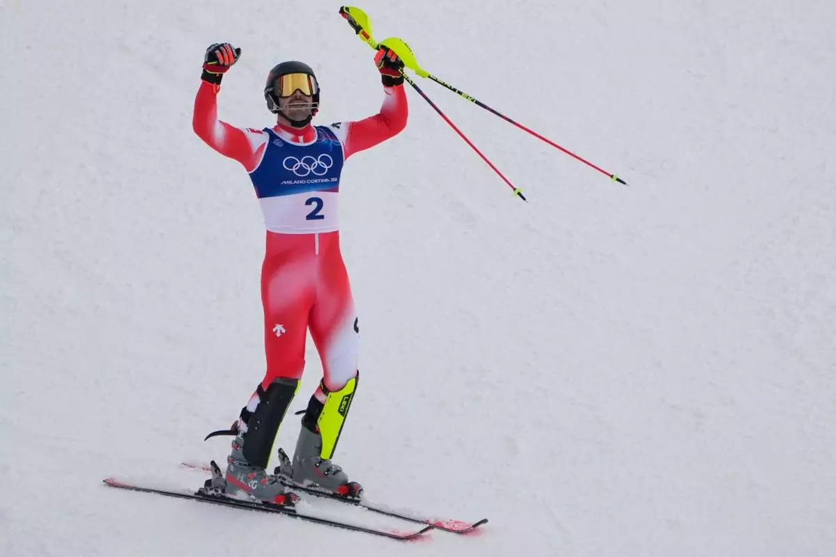 Switzerland's Loic Meillard celebrates winning an alpine ski, men's slalom race, at the 2026 Winter Olympics, in Bormio, Italy, Monday, Feb. 16, 2026. (AP Photo/John Locher)