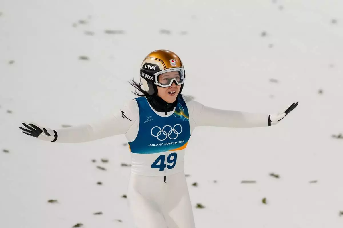 Nozomi Maruyama, of Japan, lands her final round jump of the ski jumping women's normal hill individual, at the 2026 Winter Olympics, in Predazzo, Italy, Saturday, Feb. 7, 2026. (AP Photo/Evgeniy Maloletka)