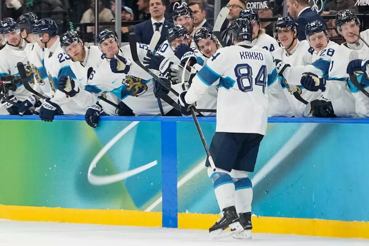 Finland's Kaapo Kakko (84) celebrates after scoring his side's fourth goal during a men's ice hockey bronze medal game between Slovakia and Finland at the 2026 Winter Olympics, in Milan, Italy, Saturday, Feb. 21, 2026. (AP Photo/Hassan Ammar)
