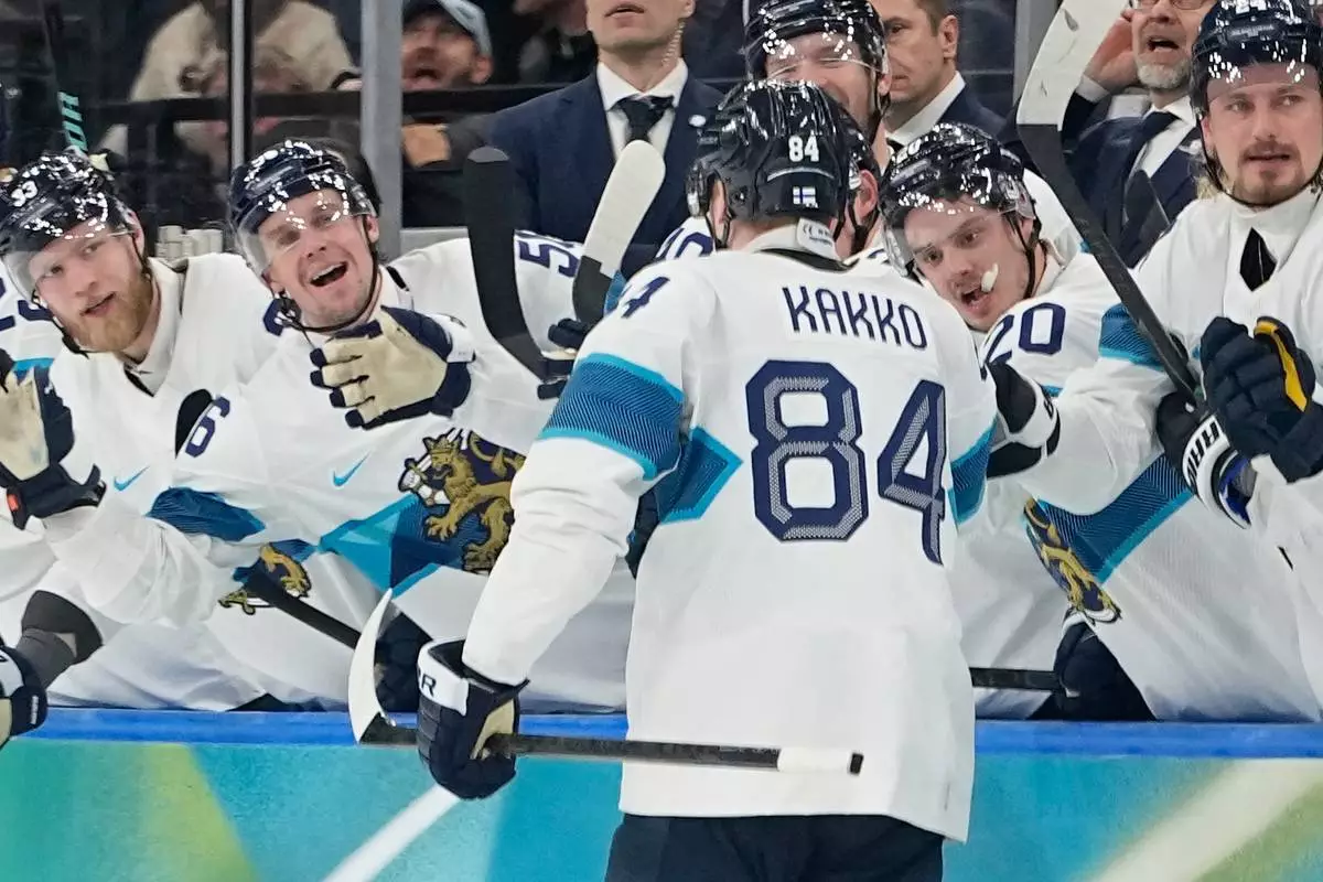 Finland's Kaapo Kakko (84) celebrates after scoring his side's fourth goal during a men's ice hockey bronze medal game between Slovakia and Finland at the 2026 Winter Olympics, in Milan, Italy, Saturday, Feb. 21, 2026. (AP Photo/Hassan Ammar)