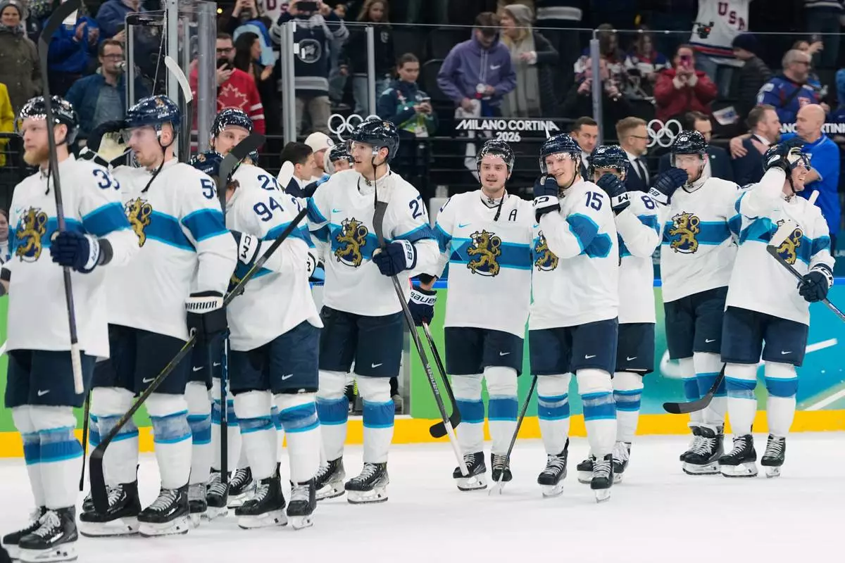 The Finland team celebrate their win in a men's ice hockey bronze medal game between Slovakia and Finland at the 2026 Winter Olympics, in Milan, Italy, Saturday, Feb. 21, 2026. (AP Photo/Petr David Josek)