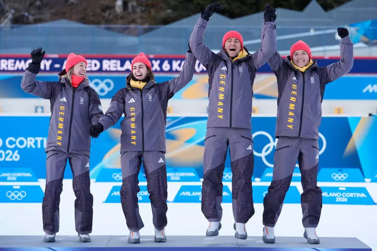 Germany's Franziska Preuss, from left, Vanessa Voigt, Philipp Nawrath and Justus Strelow celebrate bronze on the podium for the 4X6-kilometer mixed relay biathlon race at the 2026 Winter Olympics in Anterselva, Italy, Sunday, Feb. 8, 2026. (AP Photo/Andrew Medichini)