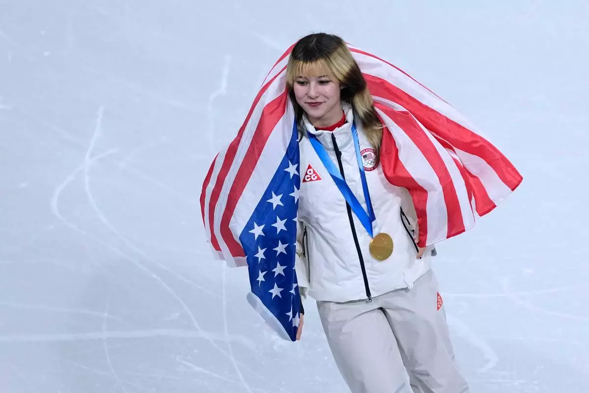 Alysa Liu of the United States celebrate with the crowd after Team USA wins gold in the figure skating team event at the 2026 Winter Olympics, in Milan, Italy, Sunday, Feb. 8, 2026. (AP Photo/Natacha Pisarenko)