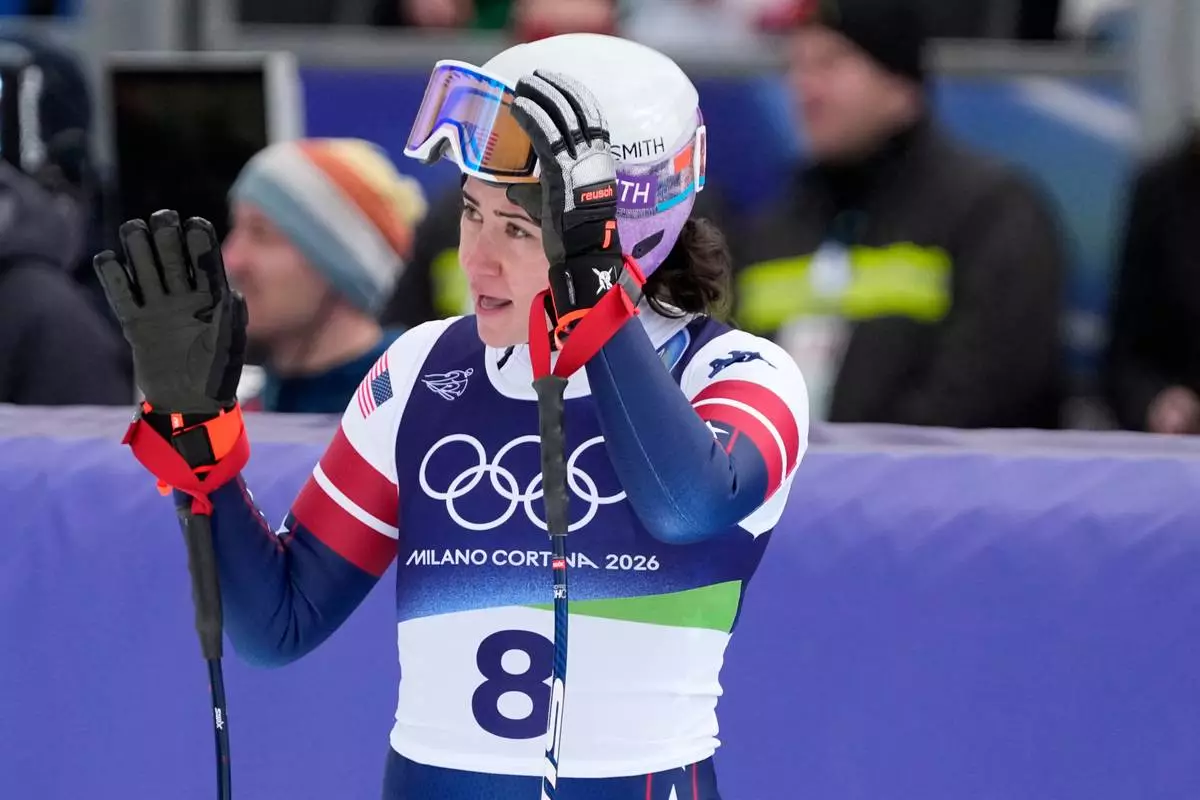 United States' Jacqueline Wiles waves at the finish area of an alpine ski, downhill portion of a women's team combined race, at the 2026 Winter Olympics, in Cortina d'Ampezzo, Italy, Tuesday, Feb. 10, 2026. (AP Photo/Andy Wong)