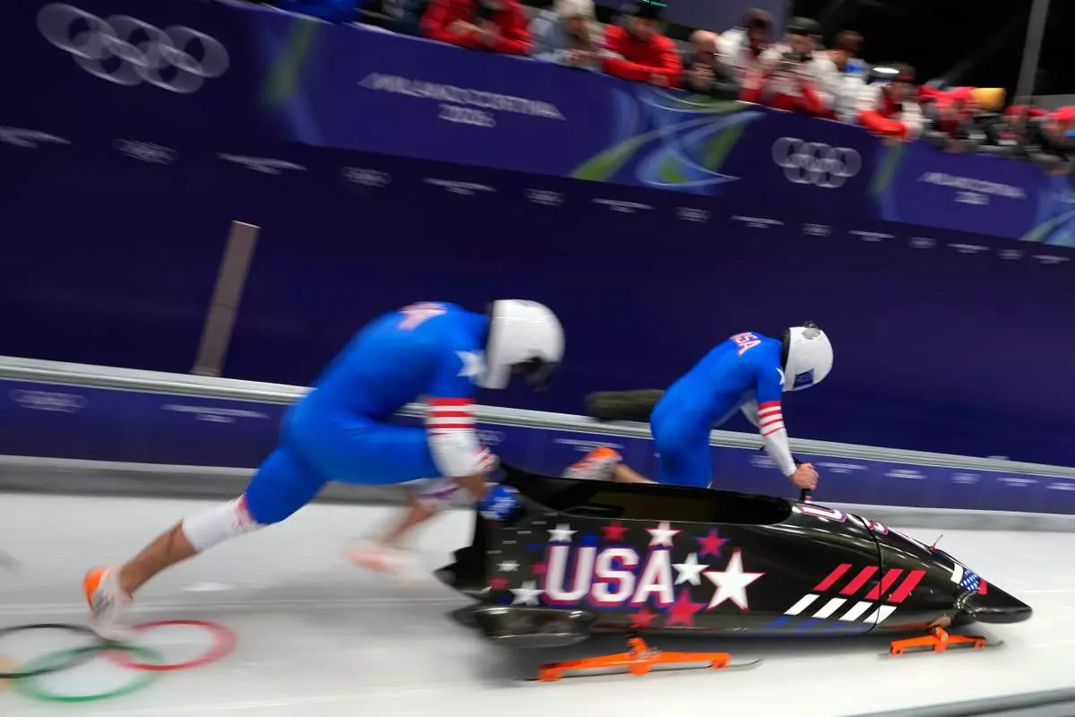 United States' Frankie del Duca, right, and Joshua Williamson start for a two man bobsled run at the 2026 Winter Olympics, in Cortina d'Ampezzo, Italy, Monday, Feb. 16, 2026. (AP Photo/Aijaz Rahi)