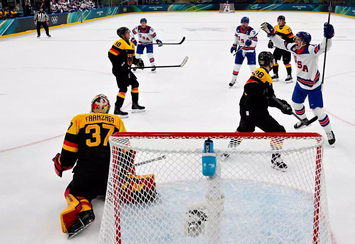 The United States Matt Boldy (12) celebrates after the team's second goal by Auston Matthews (34) during a preliminary round game of men's ice hockey between the United States and Germany at the 2026 Winter Olympics, in Milan, Italy, Sunday, Feb. 15, 2026. (Alexander Nemenov/Pool Photo via AP)