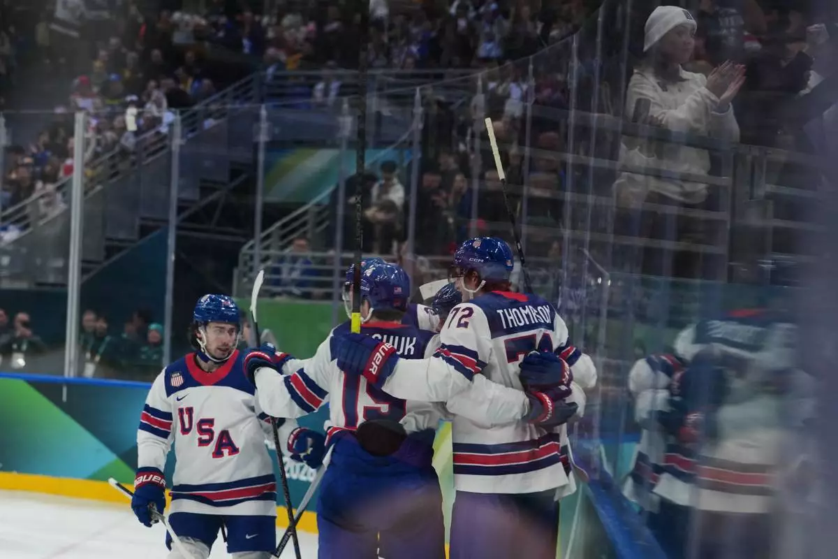 United States' Auston Matthews celebrates with his teammates after scoring his side's second goal during a preliminary round game of men's ice hockey between the United States and Germany at the 2026 Winter Olympics, in Milan, Italy, Sunday, Feb. 15, 2026. (AP Photo/Carolyn Kaster)
