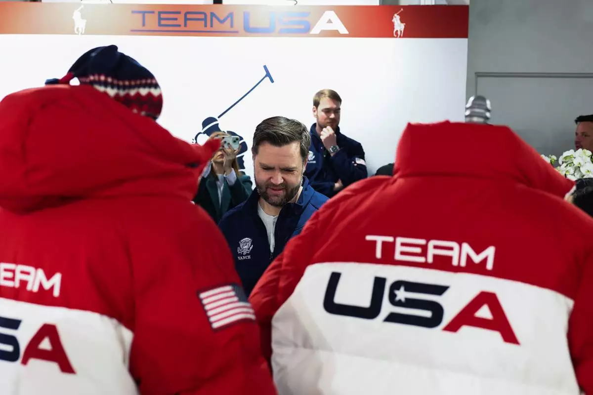 Vice President JD Vance stands by Team USA jackets, at the Team USA Welcome Experience, ahead of the Milano Cortina 2026 Winter Olympics in Milan, Italy, Thursday, Feb. 5, 2026. (Kevin Lamarque/Pool Photo via AP)