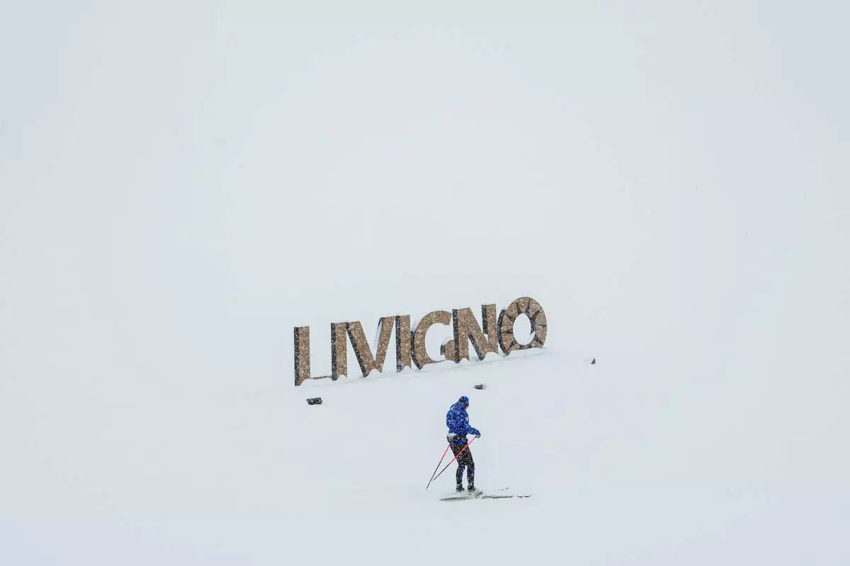 A person cross-country skis, Thursday, Feb. 19, 2026, during the 2026 Winter Olympics in Livigno, Italy. (AP Photo/Julia Demaree Nikhinson)