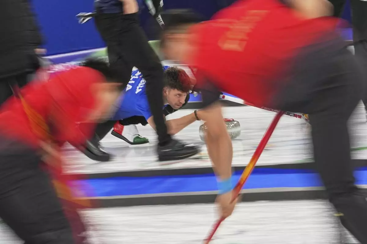Italy's Mattia Giovanella in action during the men's curling round robin session against Switzerland at the 2026 Winter Olympics, in Cortina d'Ampezzo, Italy, Thursday, Feb. 19, 2026. (AP Photo/Fatima Shbair)