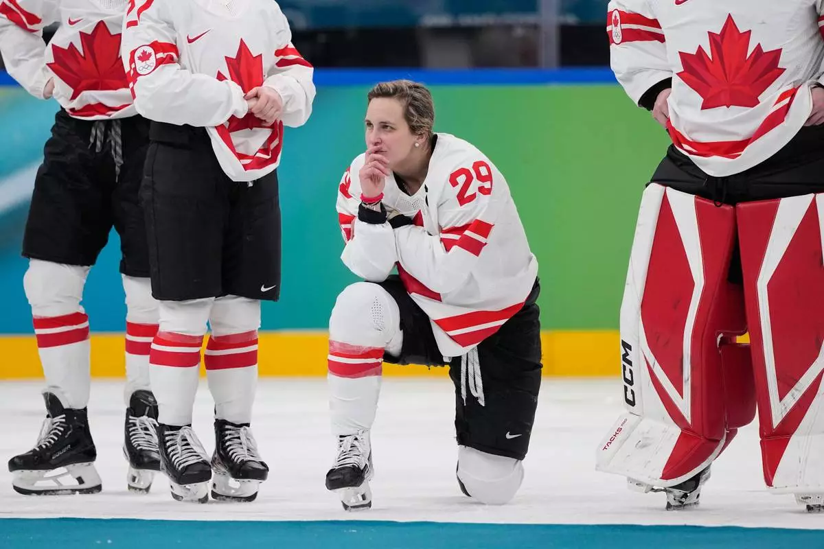 Canada's Marie-Philip Poulin (29) waits for the medal ceremony after a women's ice hockey gold medal game between the United States and Canada at the 2026 Winter Olympics, in Milan, Italy, Thursday, Feb. 19, 2026. (AP Photo/Petr David Josek)