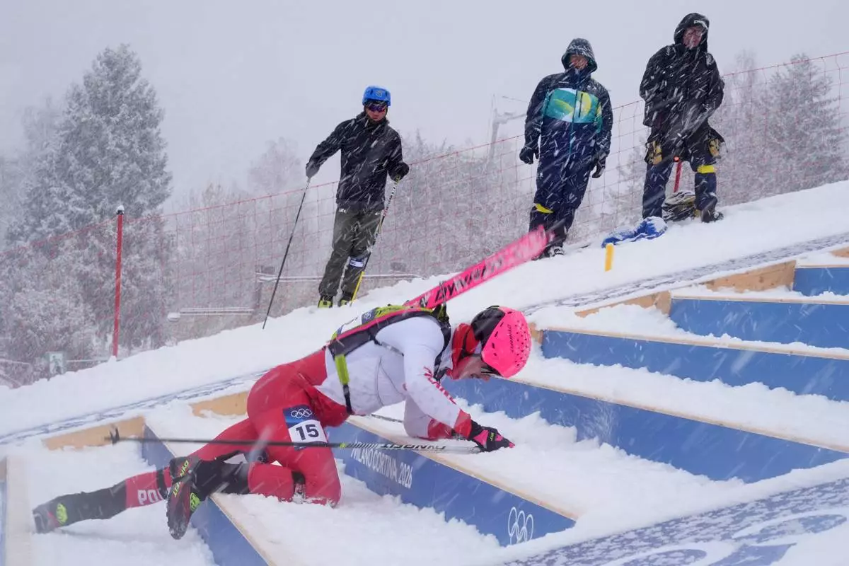 Poland's Jan Elantkowski falls as he competes during a ski mountaineering men's sprint heat, at the 2026 Winter Olympics, in Bormio, Italy, Thursday, Feb. 19, 2026. (AP Photo/Rebecca Blackwell)