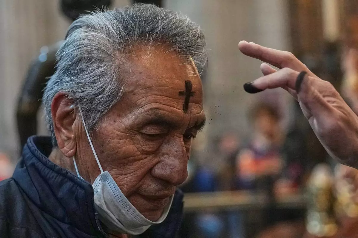 A parishioner receives ashes on Ash Wednesday in Mexico City, Wednesday, Feb. 18, 2026. (AP Photo/Marco Ugarte)