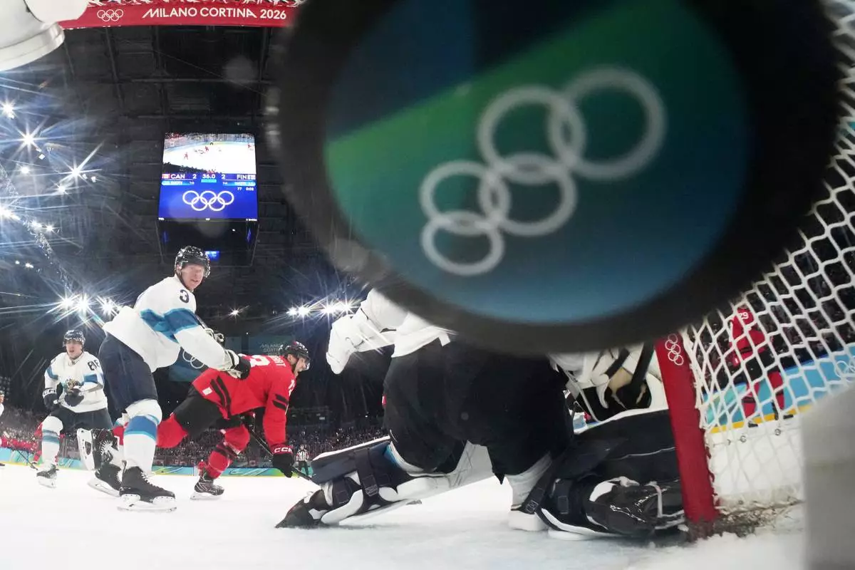Canada's Nathan MacKinnon, not seen, scores his side's third goal during a men's ice hockey semifinal game between Canada and Finland at the 2026 Winter Olympics, in Milan, Italy, Friday, Feb. 20, 2026. (Mike Segar/Pool Photo via AP)