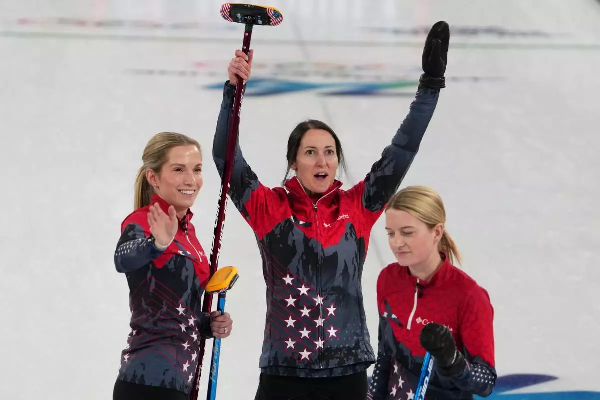United States' Tabitha Peterson, Taylor Anderson-Heide, and Cory Thiesse react after the women's curling round robin session against Canada, at the 2026 Winter Olympics, in Cortina d'Ampezzo, Italy, Friday, Feb. 13, 2026. (AP Photo/Misper Apawu)