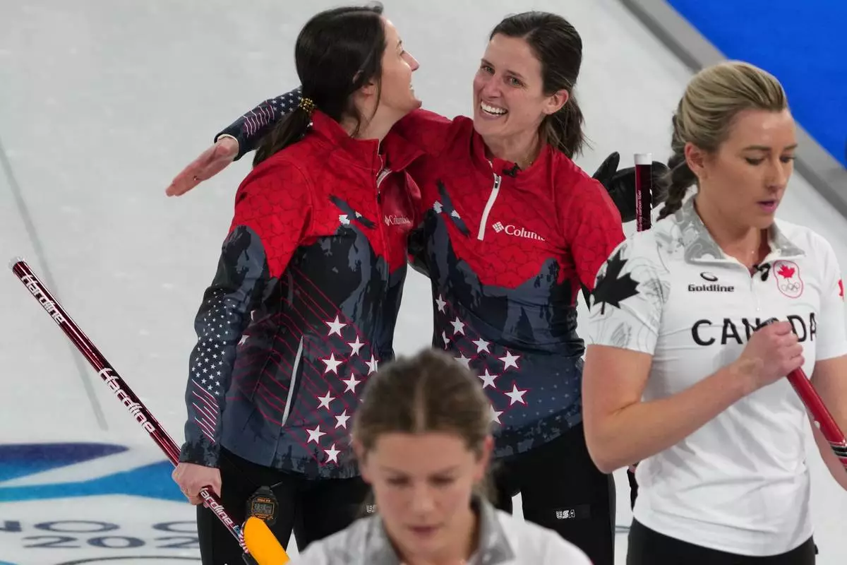 United States' Tabitha Peterson, and Tara Peterson react after the women's curling round robin session against Canada, at the 2026 Winter Olympics, in Cortina d'Ampezzo, Italy, Friday, Feb. 13, 2026. (AP Photo/Misper Apawu)