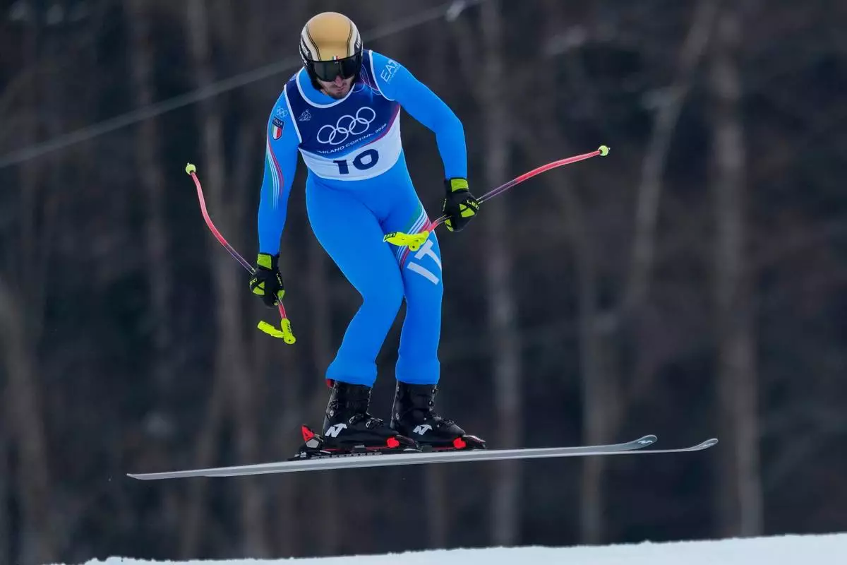 Italy's Dominik Paris speeds down the course during an alpine ski, men's downhill official training, at the 2026 Winter Olympics, in Bormio, Italy, Friday, Feb. 6, 2026. (AP Photo/Julia Demaree Nikhinson)