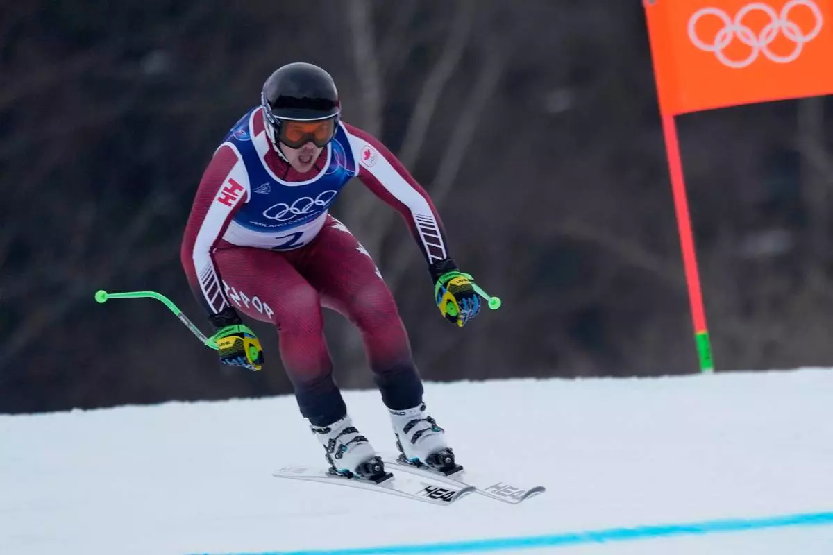 Canada's James Crawford speeds down the course during an alpine ski, men's downhill official training, at the 2026 Winter Olympics, in Bormio, Italy, Friday, Feb. 6, 2026. (AP Photo/Julia Demaree Nikhinson)