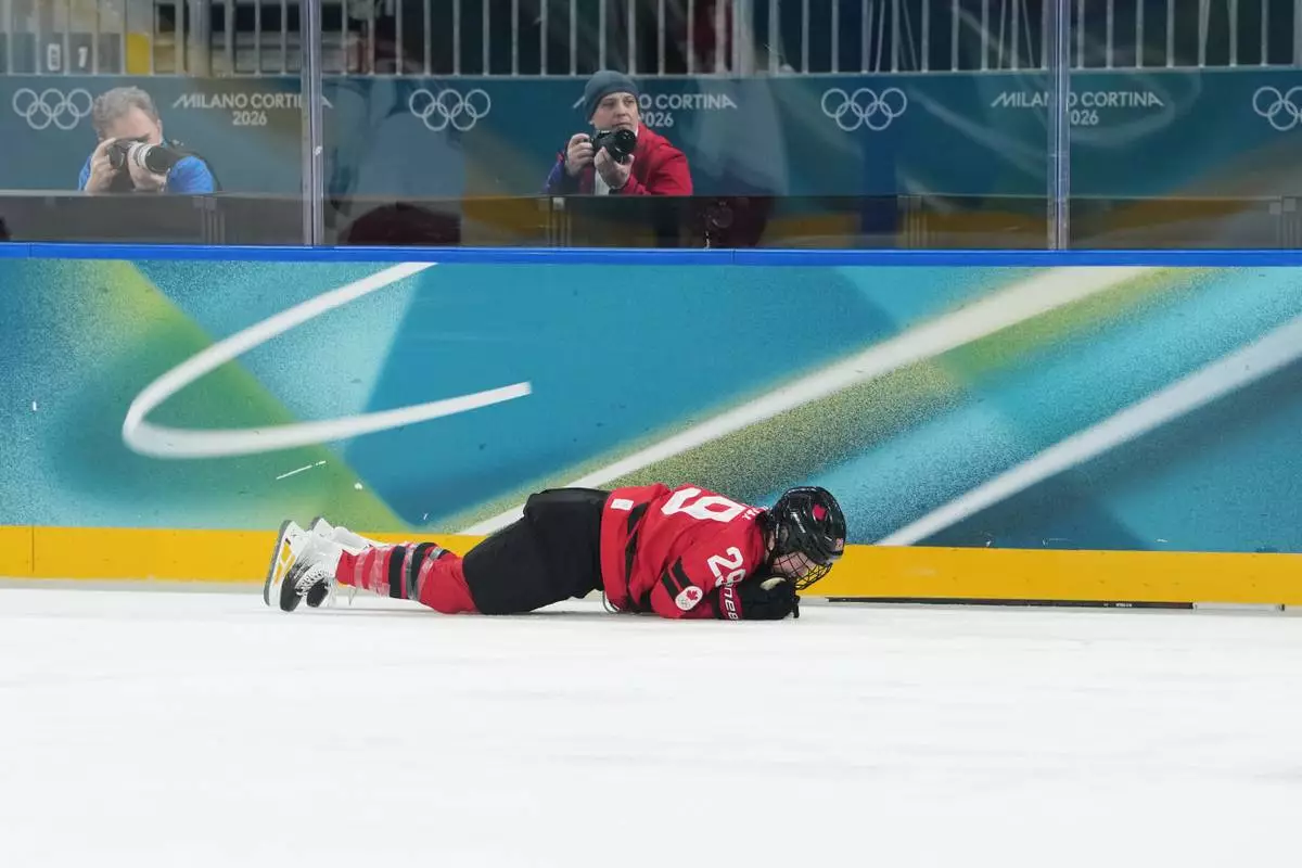 Canada's Marie-Philip Poulin (29) is down on the ice in the first period against Czechia during a preliminary round match of women's ice hockey at the 2026 Winter Olympics, in Milan, Italy, Monday, Feb. 9, 2026. (AP Photo/Carolyn Kaster)