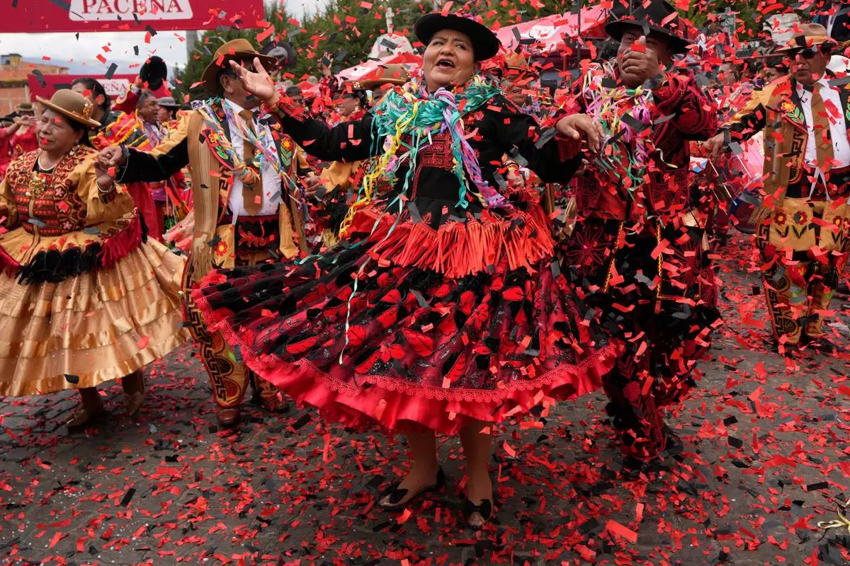 Dancers dressed as the traditional characters of Chola and Chuta perform at Carnival closing ceremonies in La Paz, Bolivia, Sunday, Feb. 22, 2026. (AP Photo/Juan Karita)