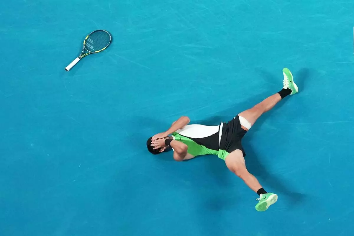 FILE - Carlos Alcaraz of Spain reacts after winning the men's singles final match against Novak Djokovic of Serbia at the Australian Open tennis championship in Melbourne, Feb. 1, 2026. (AP Photo/Dar Yasin, File)
