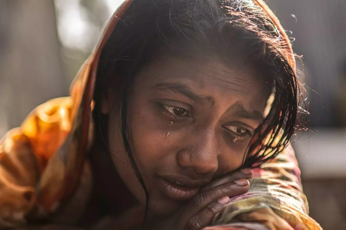 FILE - Meghna Rani, wife of Dipu Chandra Das who was beaten to death by a mob, his body hung from a tree and set on fire, for alleging making derogatory remarks about the Prophet Muhammad, weeps inside her home in Tarakanda, Bangladesh, Jan. 9, 2026. (AP Photo/Mahmud Hossain Opu, File)